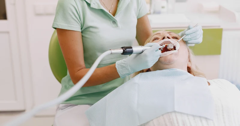 Dentist carrying out a gentle oral treatment in a bright clinic.